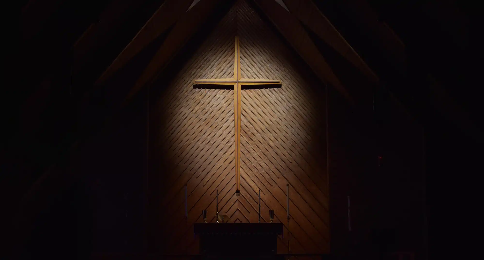light shining on cross on wall
