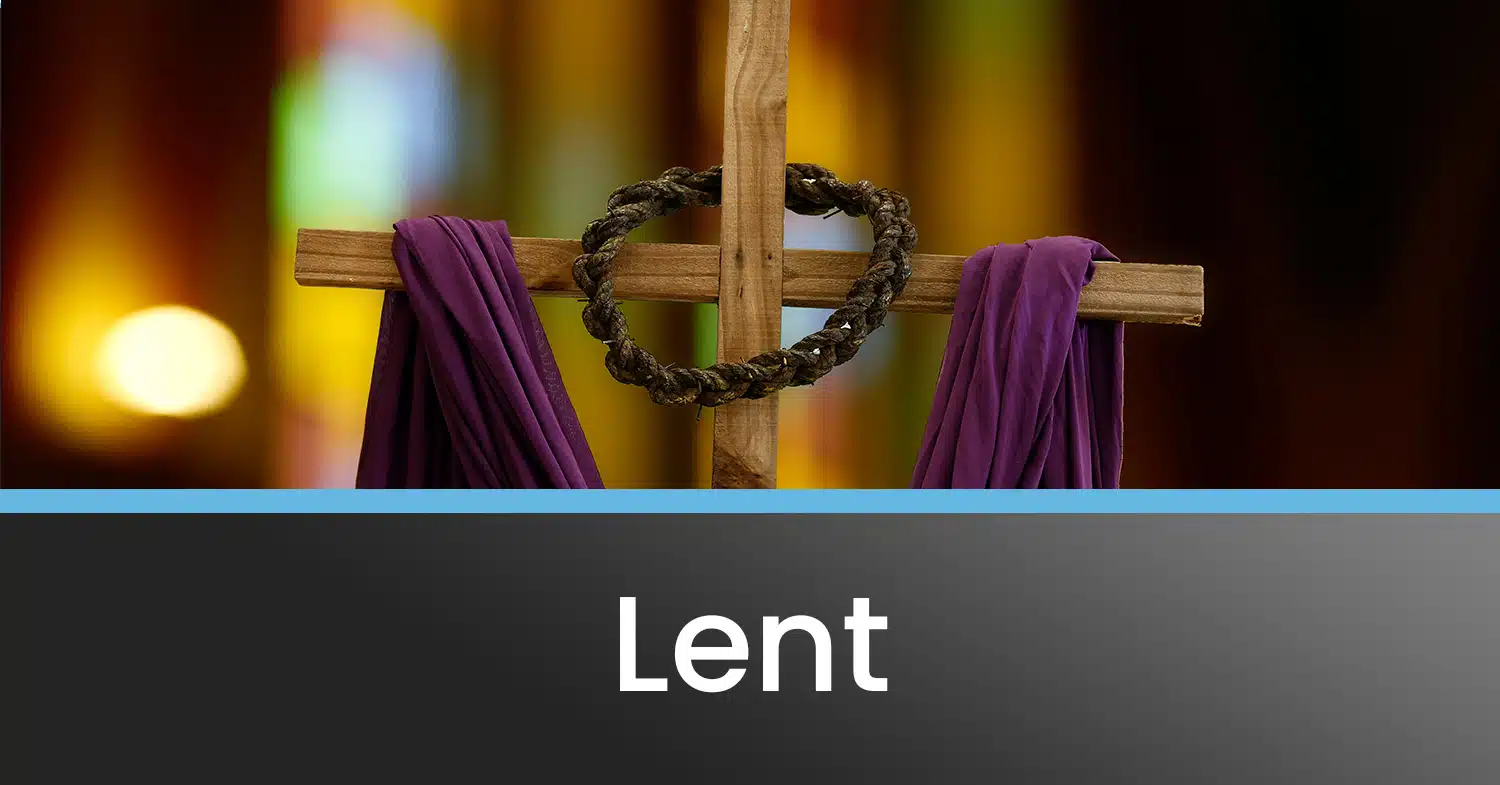 The cross with a crown of thorns and a purple drape, set up for lent services.